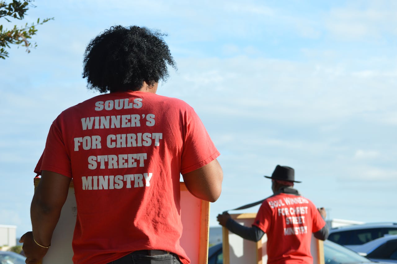 Volunteers from street ministry engaging with community outdoors, spreading positive messages.